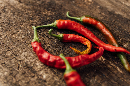 Red hot chili peppers on wooden background. Selective focus. Copy space.