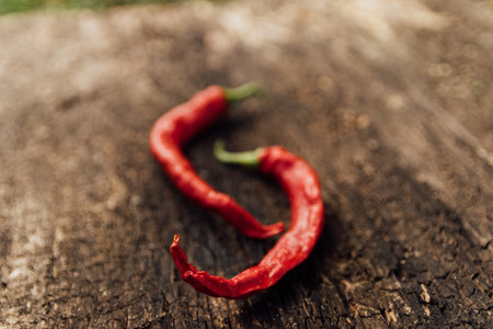 Red hot chili peppers on wooden background. Close-up, selective focus.の写真素材