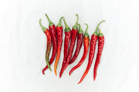 Red hot chili peppers isolated on white background. Top view, flat lay