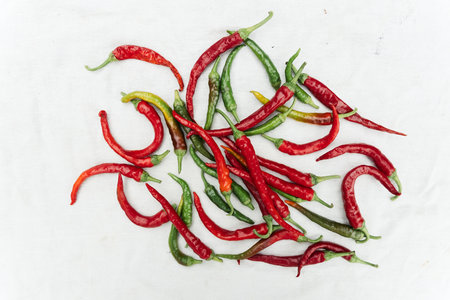 Red and green hot chili peppers on a white background. Top view.の写真素材