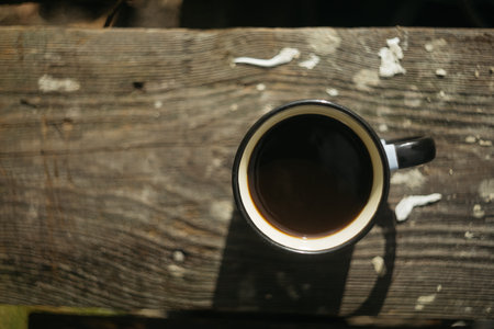 Coffee cup on the wooden table in the garden, stock photoの写真素材