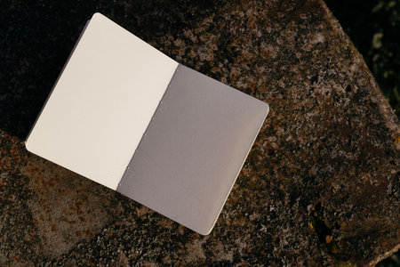 Blank notebook on stone background. Top view. Copy space.