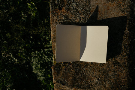 Blank white paper sheet on a stone background. Copy space.の写真素材