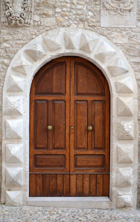 A massive medieval door in the entrance to the church, Italyの写真素材