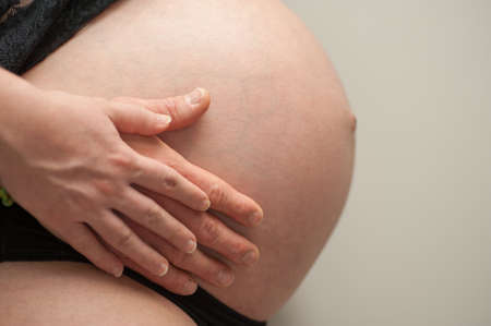 Hands on mother's tummy