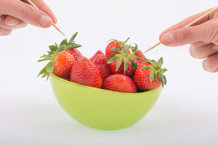 strawberries in a green bowlの写真素材