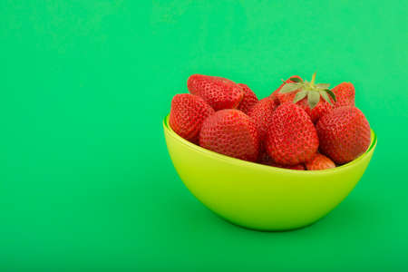 strawberries in a green bowlの写真素材