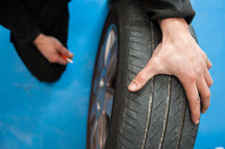 man checking tire preasureの写真素材