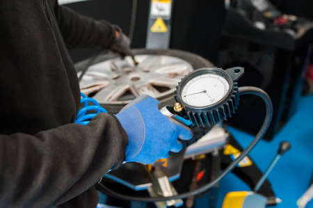 worker checking tire pressureの写真素材