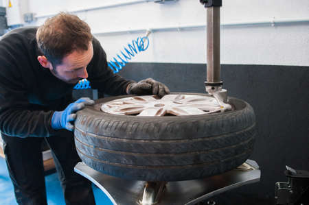 worker changing to tireの写真素材