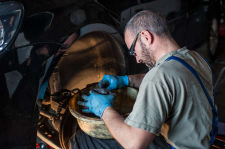 mechanic fixing a car at homeの写真素材
