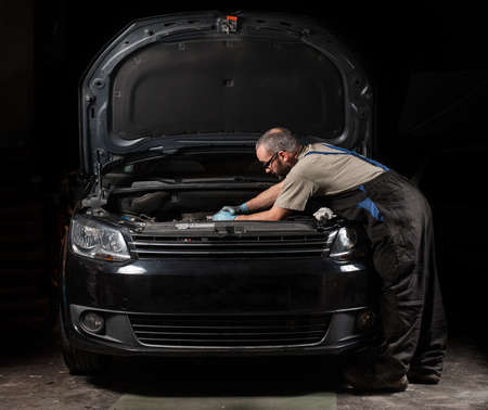 mechanic fixing a car at homeの写真素材