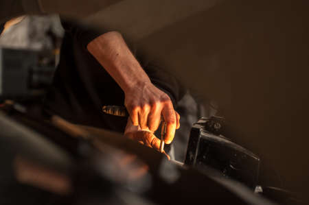 mechanic fixing a car at homeの写真素材