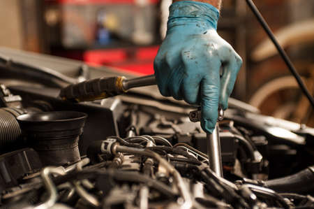 Mechanic fixing a car at homeの写真素材