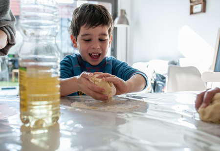 kid making cookies at homeの写真素材