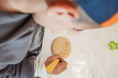 kid drawing on raw cookieの写真素材