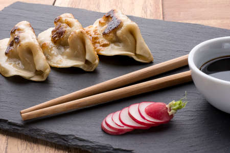 Gyoza with soy sauceの写真素材