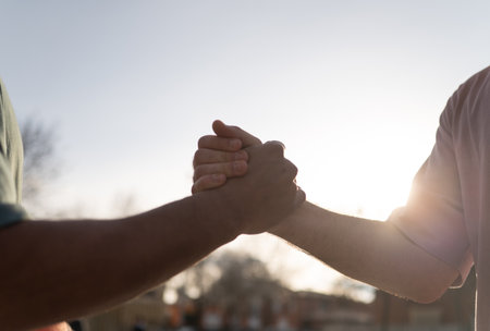 Two friends shaking hands after a basketball match, celebrating sportsmanship and friendshipの写真素材