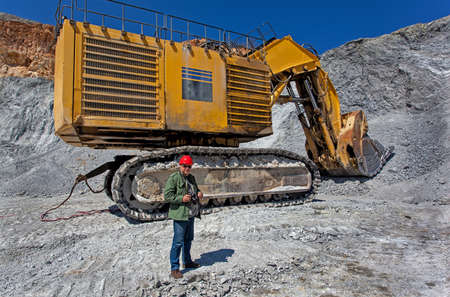 Bor, Serbia - April 15.2015 Group of tourists visiting the Open pit copper mineVeiliki Krivelj at Bor, Serbia. A close encounter with a large excavatorのeditorial素材