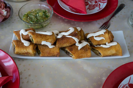 Fried pancakes stuffed with mushrooms and cheese topped with mayonnaiseの写真素材