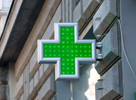 Green sign of the Red Cross as a designation for pharmacyの写真素材