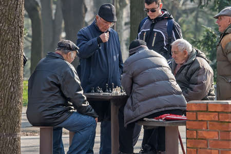 Belgrade, Serbia - February 27, 2016: The group retirees play chess in the parkのeditorial素材