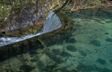 Semicircular dam with small lake that cause waterfall 01