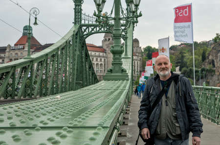 Budapest, Hungary - April  10, 2016: Male tourist poses on Freedom Bridge in Budapest  Hungary over Danube riverのeditorial素材