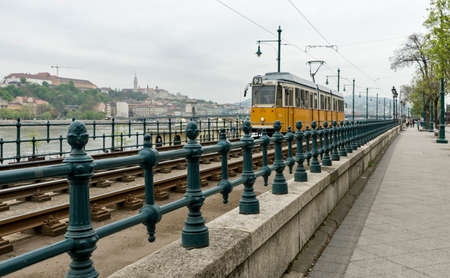 Yellow tramcar in Budapest on a cloudy dayの写真素材