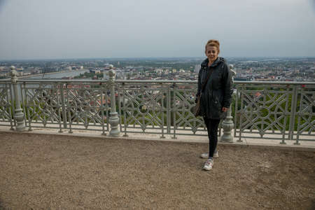 Budapest, Hungary - April, 10. 2016: SWoman tourist poses at Citadel on Gellert hill in Budapestのeditorial素材