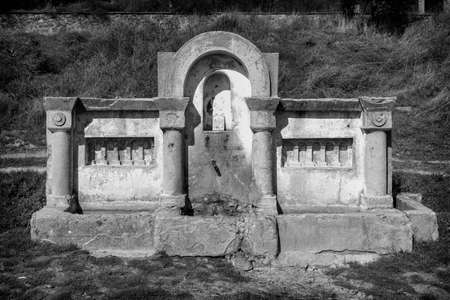 Old abandoned fountain with concrete troughの写真素材