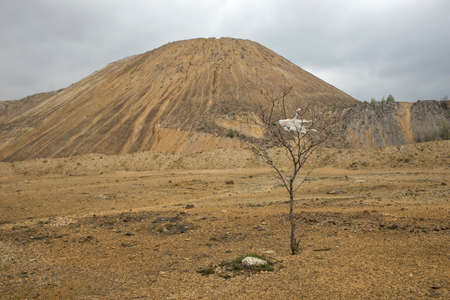 Red artificial lake and hills as a result of mining and production of copperの写真素材