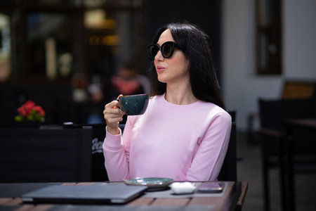 Portrait pretty trendy young brunette woman in stylish clothing with vintage cup in cafe. Elegant cute girl fashion model enjoys coffee break indoors. Morning for caffeine lovers.の写真素材