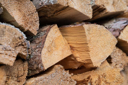 Dry birch firewood stacked in a neat woodpile. A supply of wood for kindling the fireplace. wooden...