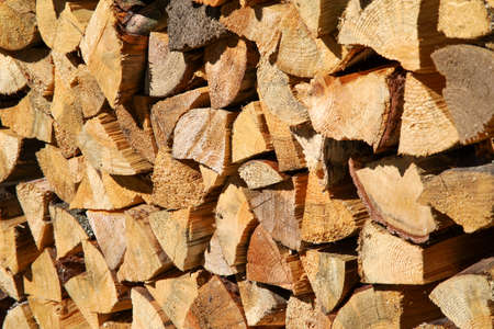 Dry birch firewood stacked in a neat woodpile. A supply of wood for kindling the fireplace. wooden texture.の写真素材
