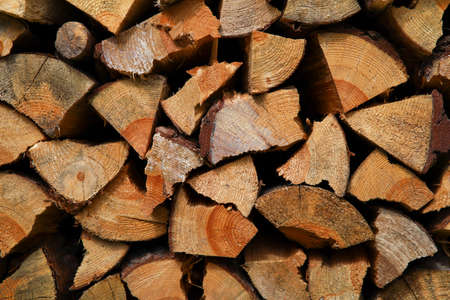 Dry birch firewood stacked in a neat woodpile. A supply of wood for kindling the fireplace. wooden texture.の写真素材