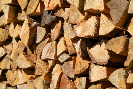 Dry birch firewood stacked in a neat woodpile. A supply of wood for kindling the fireplace. wooden texture.の写真素材
