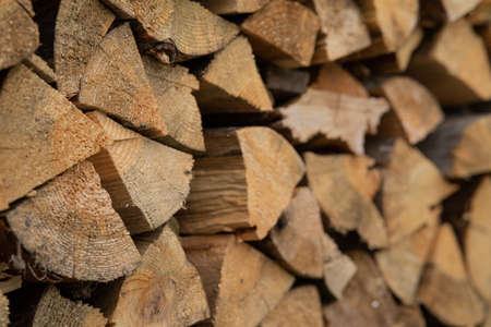 Dry birch firewood stacked in a neat woodpile. A supply of wood for kindling the fireplace. wooden texture.の写真素材
