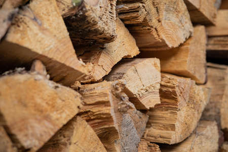 Dry birch firewood stacked in a neat woodpile. A supply of wood for kindling the fireplace. wooden texture.の写真素材