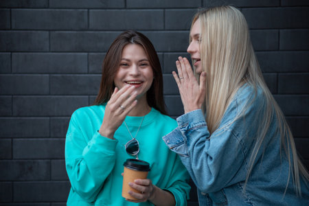 LGBT Lesbian couple love moments concept of happiness. Friends share secretsの写真素材