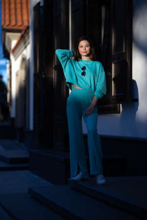 Portrait of a pretty attractive sexy young pregnant woman with natural makeup with beautiful eyes in a fashionable bright clothes. Girl is walking around the city.の写真素材