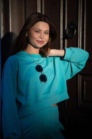 Portrait of a pretty attractive sexy young pregnant woman with natural makeup with beautiful eyes in a fashionable bright clothes. Girl is walking around the city.の写真素材