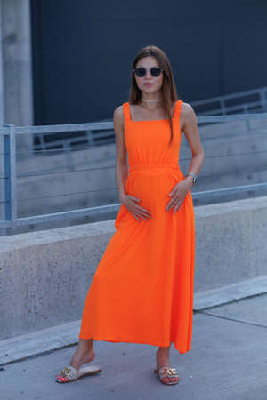 A young beautiful girl in stylish sunglasses and a bright stylish dress.の写真素材