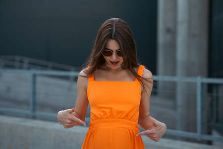 A young beautiful girl in stylish sunglasses and a bright stylish dress.の写真素材