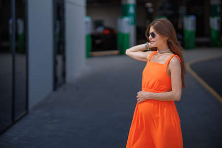 A young beautiful girl in stylish sunglasses and a bright stylish dress.の写真素材