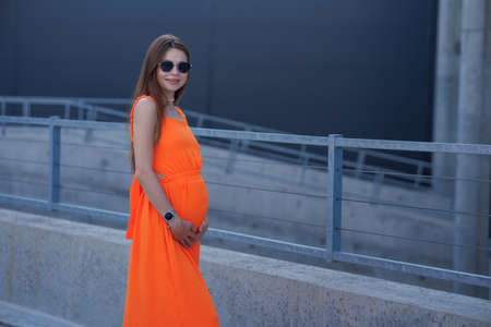 A young beautiful girl in stylish sunglasses and a bright stylish dress.の写真素材