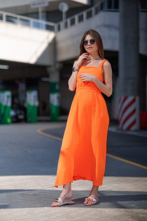 A young beautiful girl in stylish sunglasses and a bright stylish dress.の写真素材