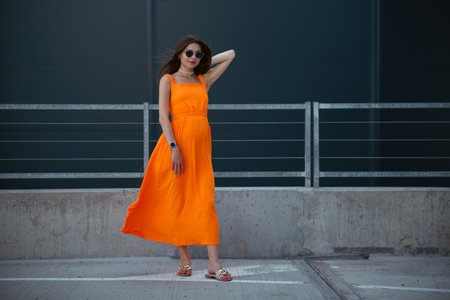 A young beautiful girl in stylish sunglasses and a bright stylish dress.の写真素材