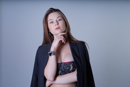 Portrait of a beautiful young woman in black lingerie and jacketの写真素材