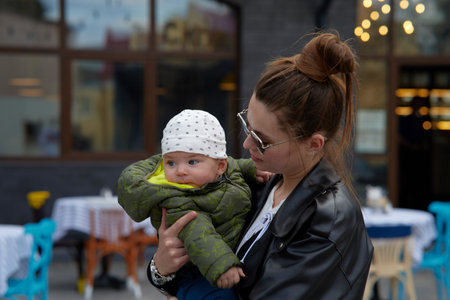 Young mother with her baby in a cafe. Shallow depth of field.の写真素材